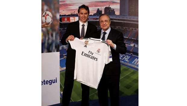 New Real Madrid coach Julen Lopetegui (left) poses with the club shirt and president Florentino Perez during his presentation in Madrid yesterday. (Reuters)
