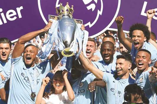 Manchester Cityu2019s captain Vincent Kompany (left) and striker Sergio Aguero lift up the Premier League trophy on May 6 in Manchester. (AFP)