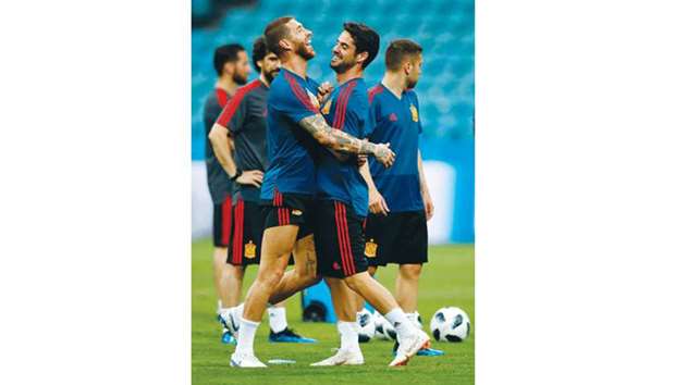 Spainu2019s defender Sergio Ramos (L) and midfielder Isco share a laugh during a training session at the Fisht Olympic Stadium in Sochi yesterday.