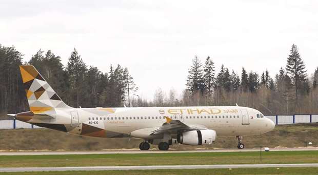 An Etihad Airways plane is seen at the National Airport Minsk, Belarus on April 19. Etihad is retreating from a strategy of seeking to close the gap to larger Gulf rivals Emirates of Dubai and Qatar Airways by investing in overseas carriers as a shortcut to growth.