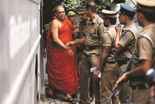 Galaboda Aththe Gnanasara Thero, head of Buddhist group Bodu Bala Sena, walks towards a prison bus after he was sentenced by a court in Homagama, Sri Lanka.