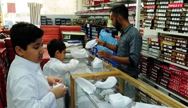 Qatari children select new caps as part of Eid al-Fitr shopping in Doha on Thursday. PICTURE: Nasar T K.