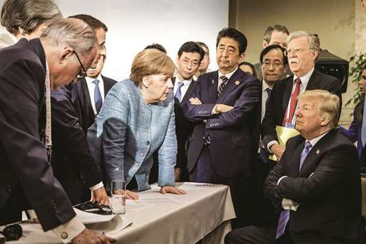 German Chancellor Angela Merkel speaks to US President Donald Trump during the second day of the G7 meeting in Charlevoix city of La Malbaie, Quebec, Canada, on June 9.