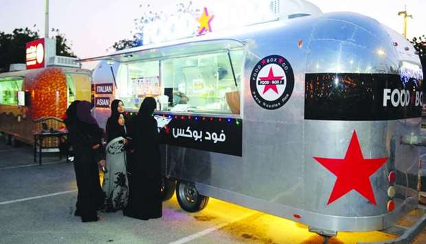 Customers place their orders at one of the food trucks outside the Khalifa International Stadium. PICTURE: Nasar TK