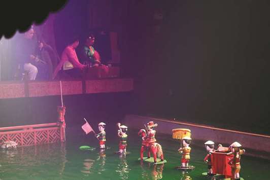 Vietnamese singers and musicians rendering accompaniment during a water puppet performance at the Thang Long theatre in Hanoi.