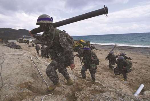 A file picture shows South Korean Marines moving into position on a beach during a joint landing operation by US and South Korean Marines in the southeastern port of Pohang.