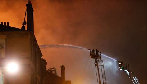 Firefighters attend to a blaze at the Mackintosh Building at the Glasgow School of Art, which is the second time in four years
