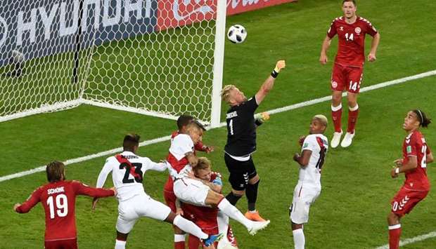 Denmark's goalkeeper Kasper Schmeichel (C) comes out to punch the ball from a corner.