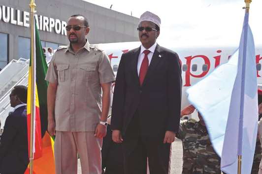 Ethiopian Prime Minister Abiy Ahmed, left, is received by Somalia President Mohamed Abdullahi Farmaajo at Aden Alle airport in Mogadishu yesterday.