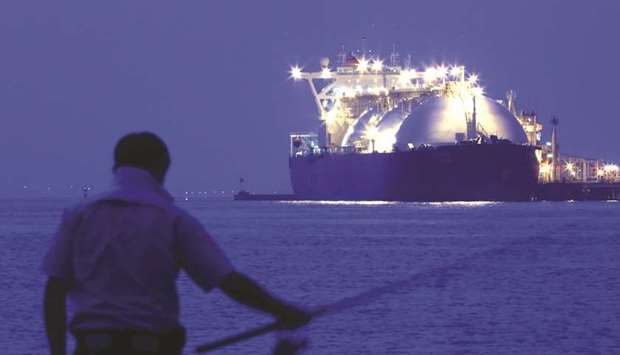 A man fishes in front of a liquefied natural gas tanker berthed at a gas-fired thermal power plant in Futtsu, Chiba Prefecture, Japan (file). A consensus statement from G20 energy ministers meeting in Argentina cited the potential of natural gas u201cto expand significantly over the coming decades.u201d