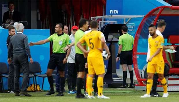 Referee Andres Cunha reviews a incident on VAR before awarding a penalty to France on Saturday.