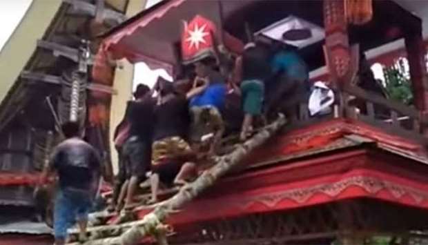 Pallbearers lost their footing while carrying the coffin up a bamboo ladder. Picture: Twitter