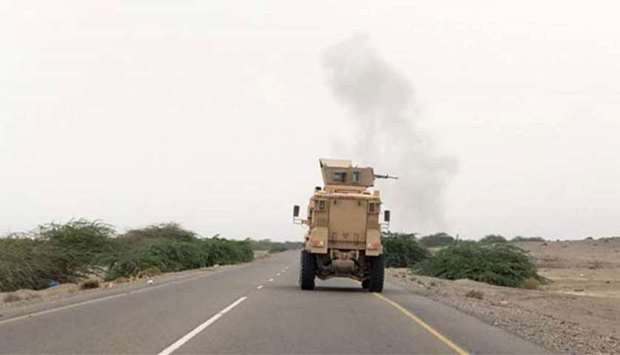 An armoured vehicle fires a heavy mahcine gun as Yemeni pro-government forces attack Houthi rebel positions in the Hodeida province on Saturday.