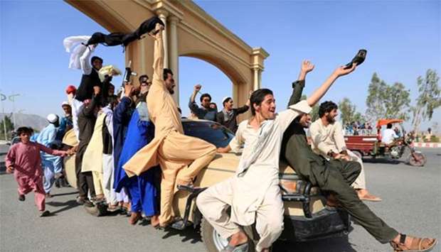 People celebrate ceasefire in the Rodat district of Nangarhar province on Saturday.