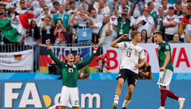 Mexico's Edson Alvarez and Carlos Salcedo celebrate at full time as Germany's Thomas Muller looks dejected. Reuters
