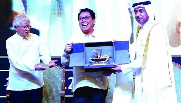 Philippine labour secretary Silvestre Bello III (centre) and HE Minister of Administrative Development, Labour and Social Affairs Dr Issa Saad al-Jafali al-Nuaimi (right) exchange gifts and memorial shields as Philippine ambassador Alan Timbayan looks on. PICTURE: Ram Chand.
