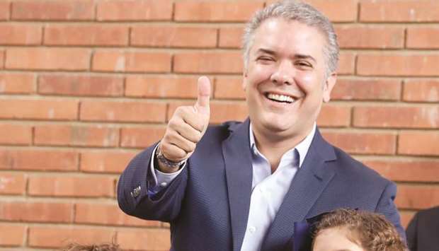 Presidential candidate Ivan Duque gestures after casting his vote at a polling station, during the presidential election in Bogota, Colombia, yesterday.