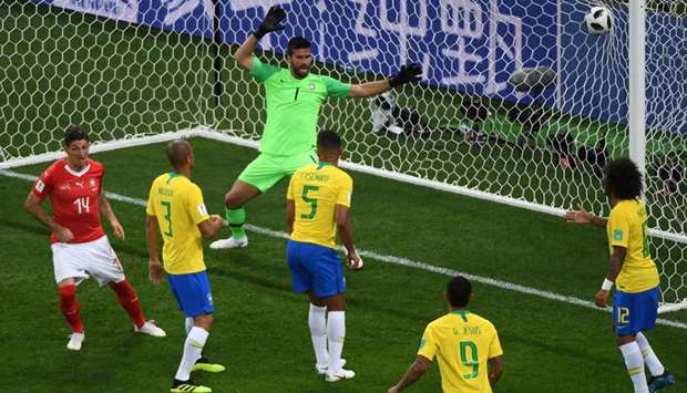 Switzerlandu2019s Steven Zuber (left) scores past Brazilu2019s goalkeeper Alisson during the 2018 FIFA World Cup Group E match in Rostov-on-Don, Russia, yesterday. (AFP)