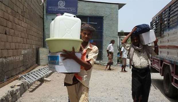 Displaced Yemenis receive aid at a school in the city of Hodeidah after being evacuated from a village near Hodeidah airport amid battles between government forces and Houthi fighters on Sunday.