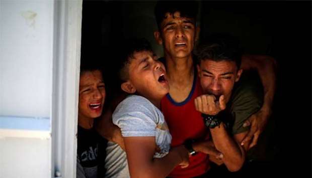 Relatives of a Palestinian killed at the Gaza border react at a hospital in Gaza City on Monday.