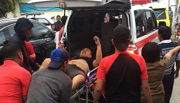 A survivor been taken away in an ambulance after a boat overturned in Lake Toba in the province of North Sumatra in Indonesia.