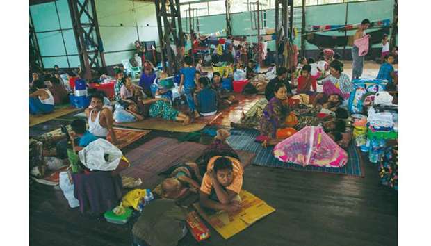 Residents displaced by the floods take shelter in a stadium in the township of Mawlamyine district in Mon state.