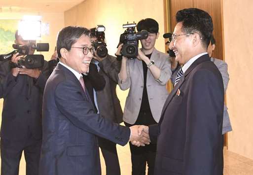 South Koreau2019s chief delegate Jeon Choong-ryul (left) with his North Korean counterpart Won Kil U during their talks regarding unified teams for the Asian Games at the south side of the truce village of Panmunjom yesterday. (AFP)