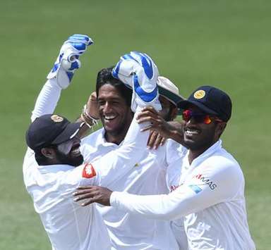 Kasun Rajitha (centre) of Sri Lanka celebrates the dismissal of Devon Smith of West Indies during day 5 of the 2nd Test at Daren Sammy Cricket Ground, Gros Islet, St. Lucia, yesterday. (AFP)
