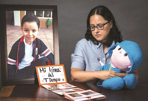 Single mother Miriam Rodriguez Guise who lost her 7-year-old son Jose Eduardo in the earthquake of September 19, 2017, shows the album My Timeline that she made with her son.