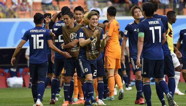 Japan's defender Gotoku Sakai (C) and teammates celebrate their 2-1 victory