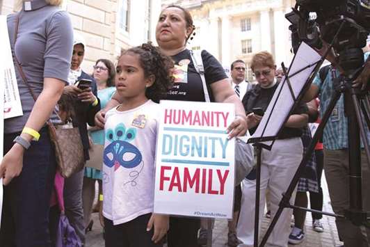 A mother and daughter look on during a rally against the separation of immigrant minors and their parents outside the US Customers and Border Protection headquarters in Washington, DC yesterday.