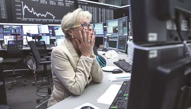 A trader monitors financial data at the Frankfurt Stock Exchange. The DAX 30 closed down 1.2% to 12,677.97 points yesterday.