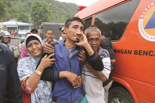 Survivors and family members react as they meet each other at the Lake Toba ferry port in the province of North Sumatra after a boat capsized on Monday.