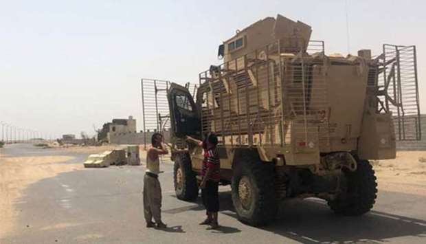 Yemeni pro-government forces backed by the Saudi-led Arab military alliance advance in their fight against Houthi rebels in the area of Hodeida's airport on Monday.