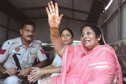 Former prisoner Nasreen Akhtar, 56, waves as she is released yesterday from Amritsar Central Jail on the outskirts of Amritsar. India has released six Pakistani prisoners at their land border in Punjab, the first such gesture since signing a deal for an  exchange of inmates in their jails.