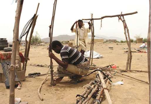 Displaced Yemenis from Hodeidah build a shelter at a make-shift camp in the northern district of  Hajjah province.