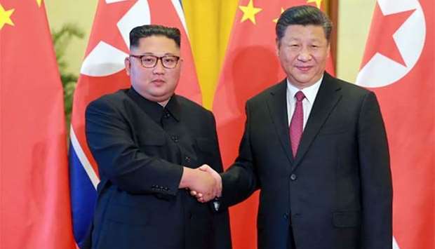 North Korean leader Kim Jong Un shaking hands with Chinese President Xi Jinping at the Great Hall of the People in Beijing.