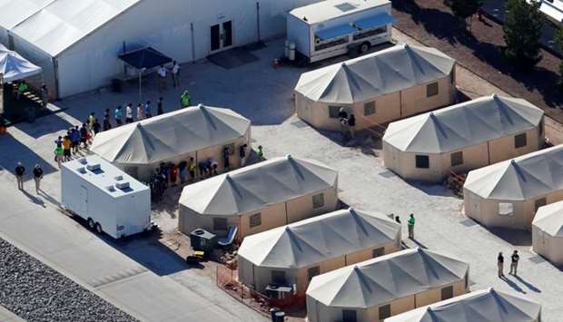 Immigrant children now housed in a tent encampment under the new ,zero tolerance, policy by the Trump administration are shown walking in single file at the facility near the Mexican border in Tornillo, Texas. Reuters