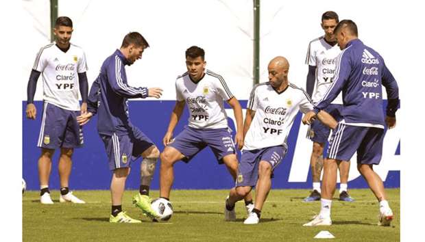 Argentinau2019s Lionel Messi (second from left) vies for the ball with Marcos Acuna (third from left) and Javier Mascherano (third from right) during a training session on the eve of their Group D match against Croatia in Bronnitsy, near Moscow, Russia, yesterday. (AFP)