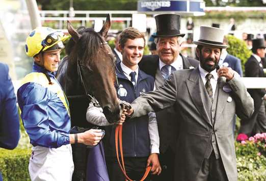 James Doyle on Poetu2019s Word celebrates winning the 4.20 Prince of Walesu2019s Stakes with owner Saeed Suhail and trainer Michael Stoute at the Royal Ascot yesterday. (Reuters)