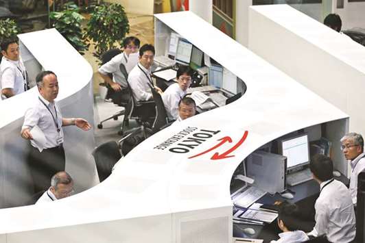 Traders work at the Tokyo Stock Exchange. The Nikkei 225 closed up 1.2% to 22,555.43 points yesterday.