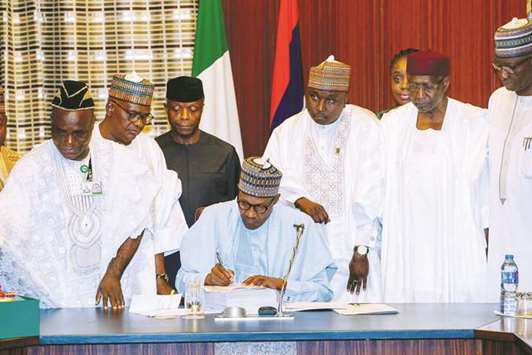 Nigeriau2019s President Muhammadu Buhari signs the 2018 budget in Abuja, Nigeria.