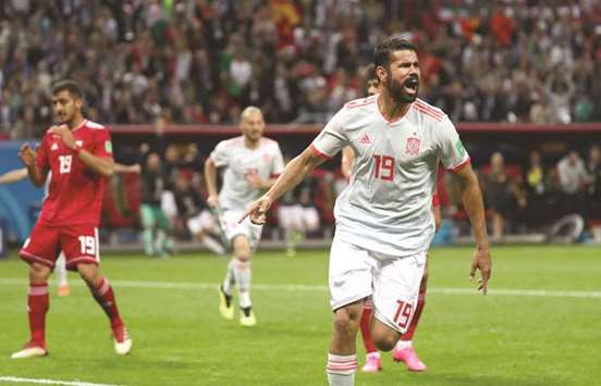 Spainu2019s Diego Costa celebrates after scoring a goal against Iran yesterday. (Reuters)