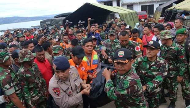 Indonesian security forces and rescue workers carry a victim recovered after a ferry sank in Lake Toba, at Tigaras Port in Simalungun, North Sumatra, on Wednesday.