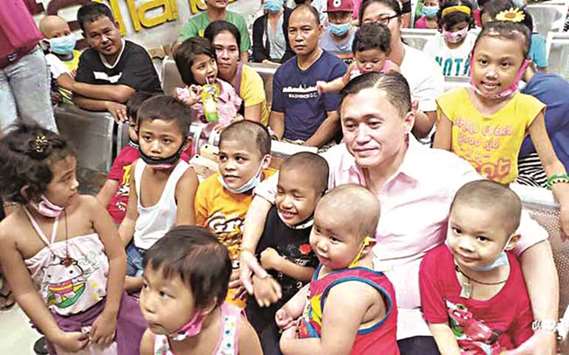 Special Assistant to the President Christopher u201cBongu201d Go poses with young patients at the Philippine Childrenu2019s Medical Center.