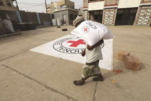 A displaced man receives aid kits distributed by the (ICRC) International Committee of the Red Cross in the war-torn Red Sea port city of Hodeidah.