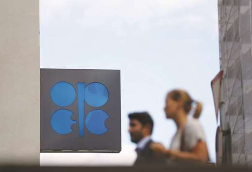 Two pedestrians pass the Opec logo in front of the groupu2019s headquarters in Vienna, Austria. A production rise of about 1mn bpd, or around 1% of global supply, was emerging as a  consensus for the group and its allies, Opec sources told Reuters, adding that Iran could agree under certain conditions.
