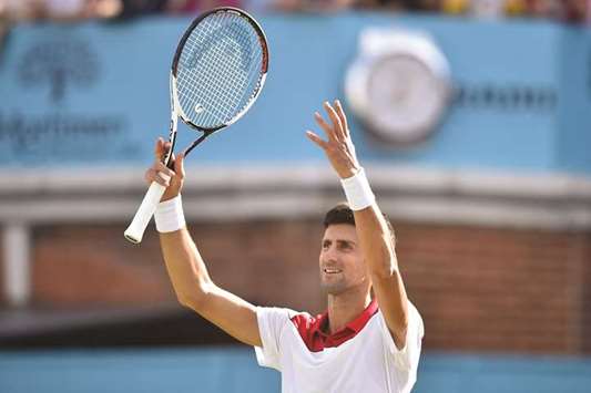 Serbiau2019s Novak Djokovic applauds the crowd after winning against Bulgariau2019s Grigor Dimitrov during the second round match of the Queenu2019s Club Championships in London yesterday. (AFP)