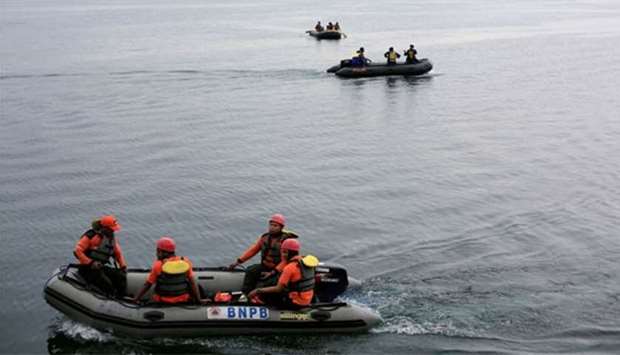 Rescue team members use rubber boats to find missing passengers from a ferry accident at the Lake Toba at Tigaras port in Simalungun, North Sumatra on Thursday.