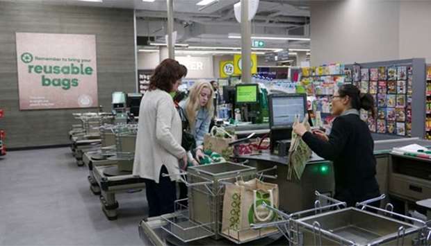 Shoppers check out at a plastic bag-free Woolworths supermarket in Sydney.